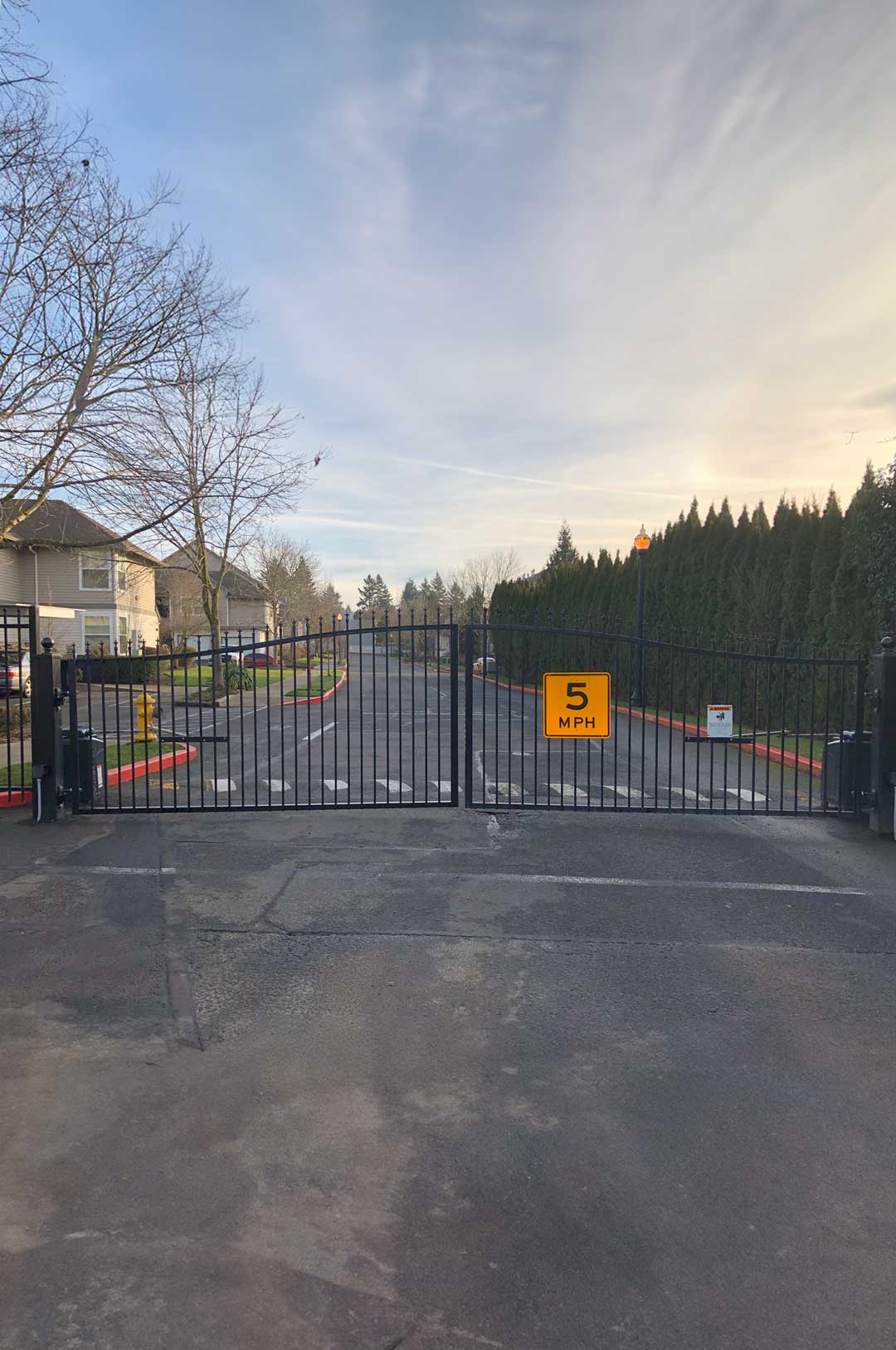 Steel security gate at a residential community entrance