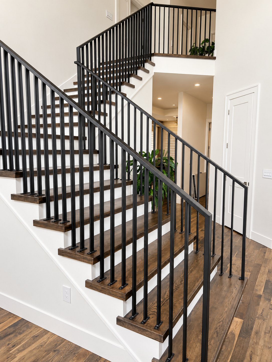 Black vertical-picket metal stair railing in a Portland-area home
