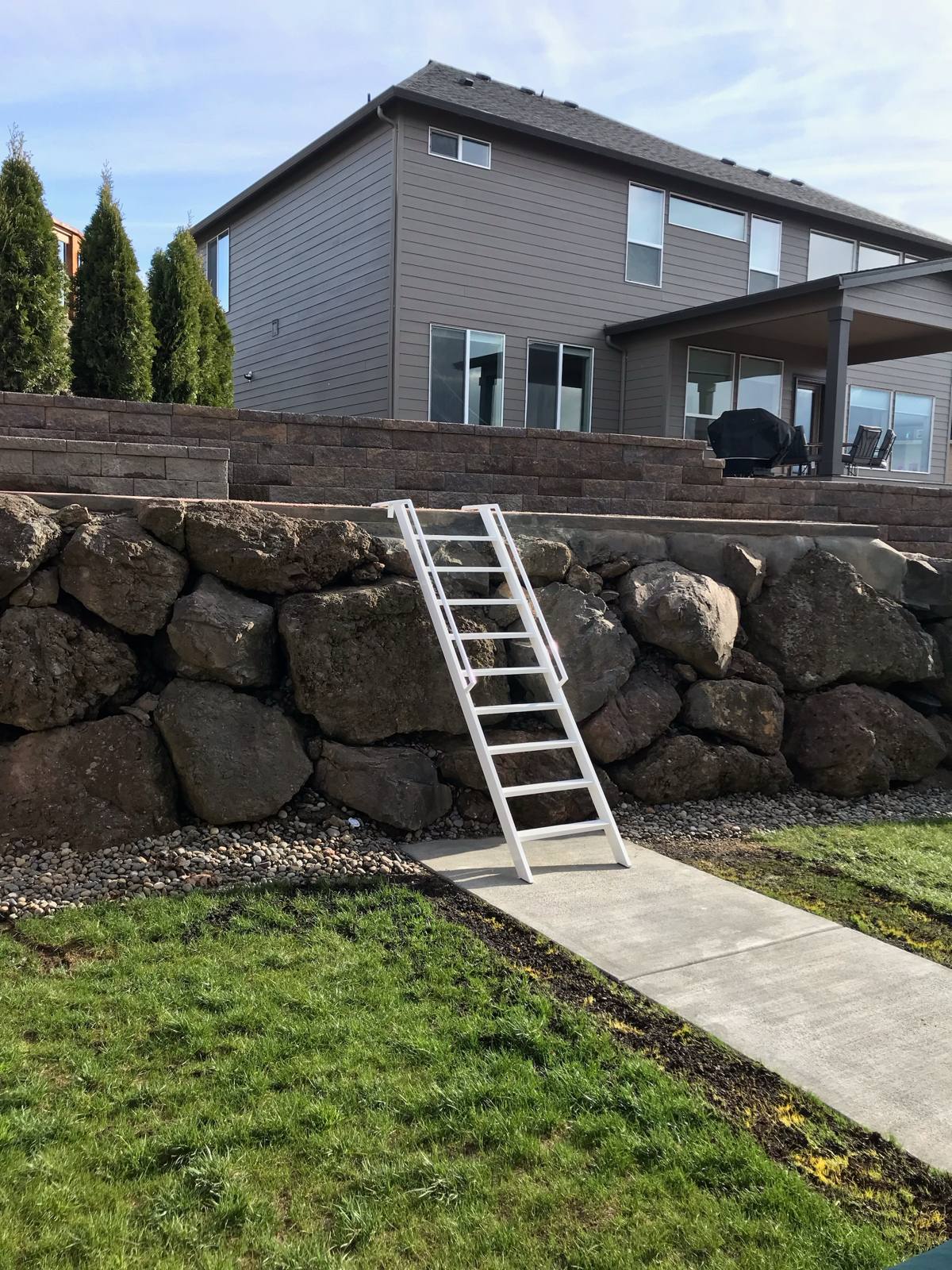 Custom steel ladder over a rock retaining wall — Portland, OR