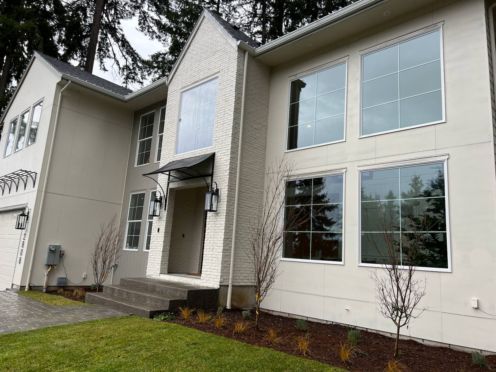 Custom steel entry awning with curved brackets — Vancouver, WA area
