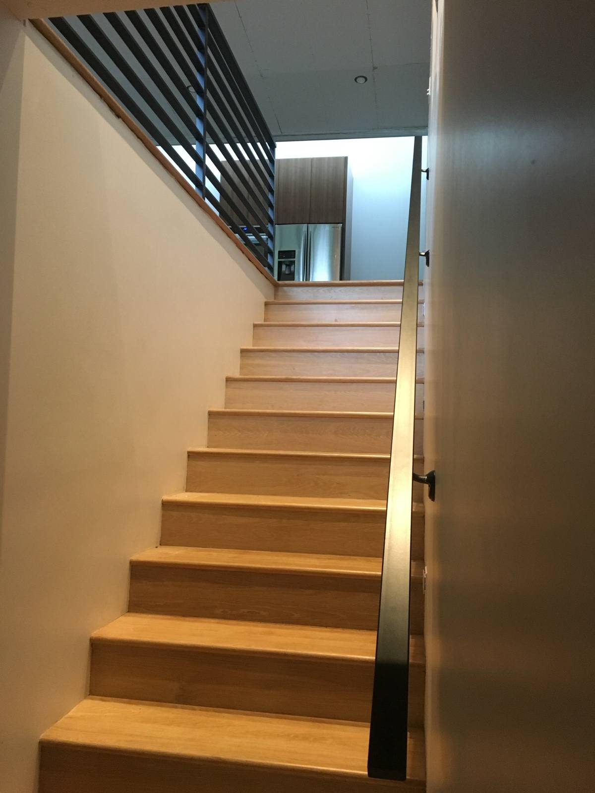 Modern horizontal-bar metal stair railing in a Portland-area home