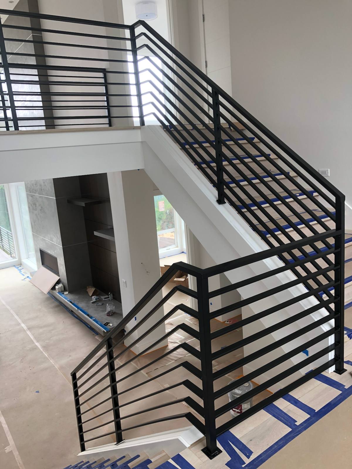 Modern horizontal-bar metal stair railing — measured, welded and installed on site