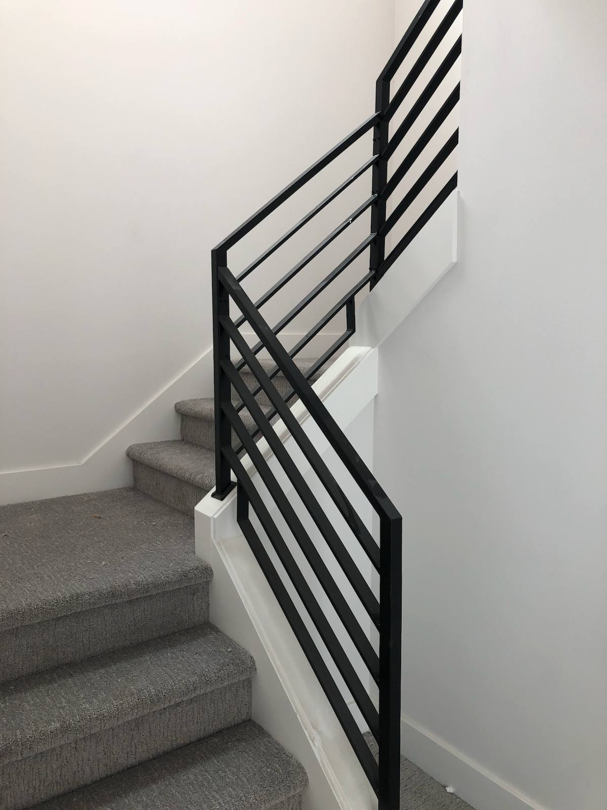 Modern horizontal-bar metal stair railing in a Vancouver, WA area home