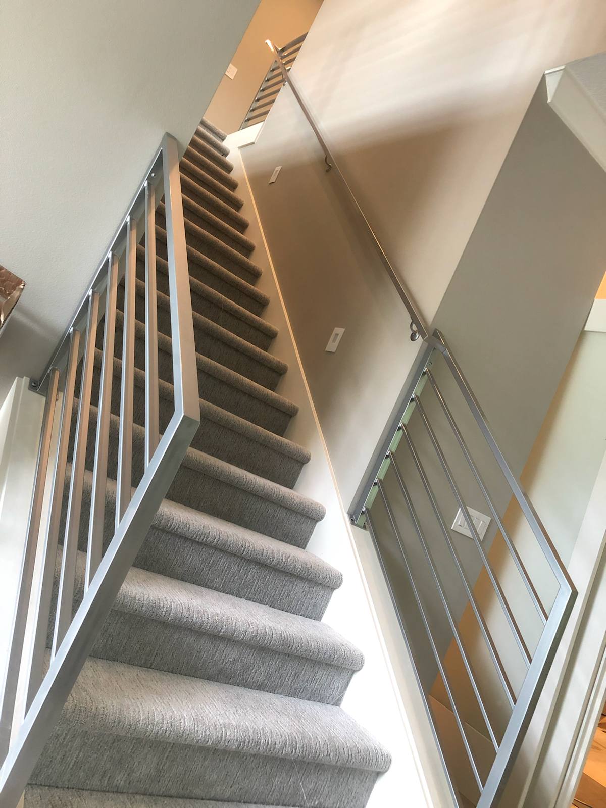 Modern horizontal-bar metal stair railing — custom built and installed in Portland, OR