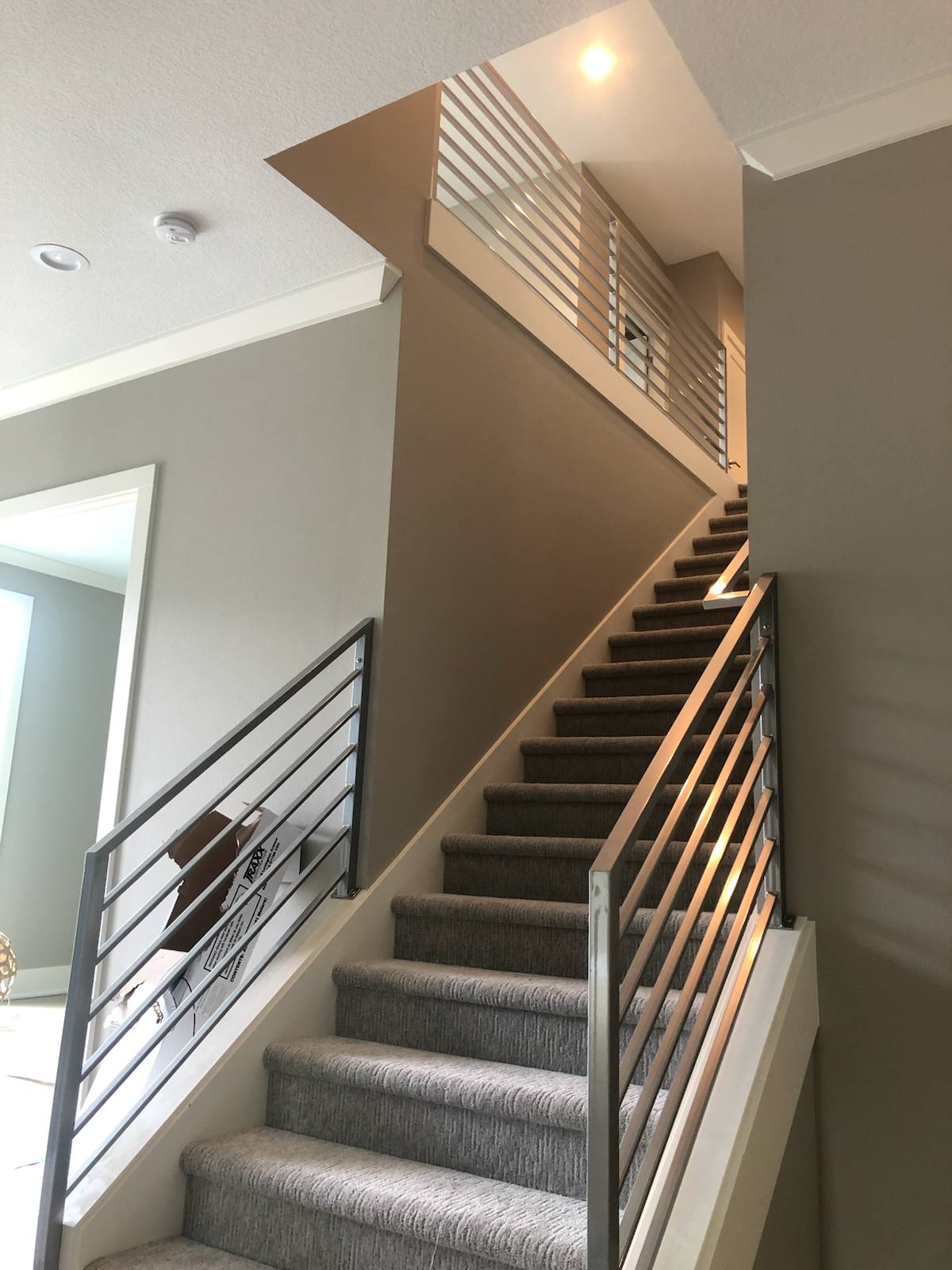 Modern horizontal-bar metal stair railing in a Portland-area home