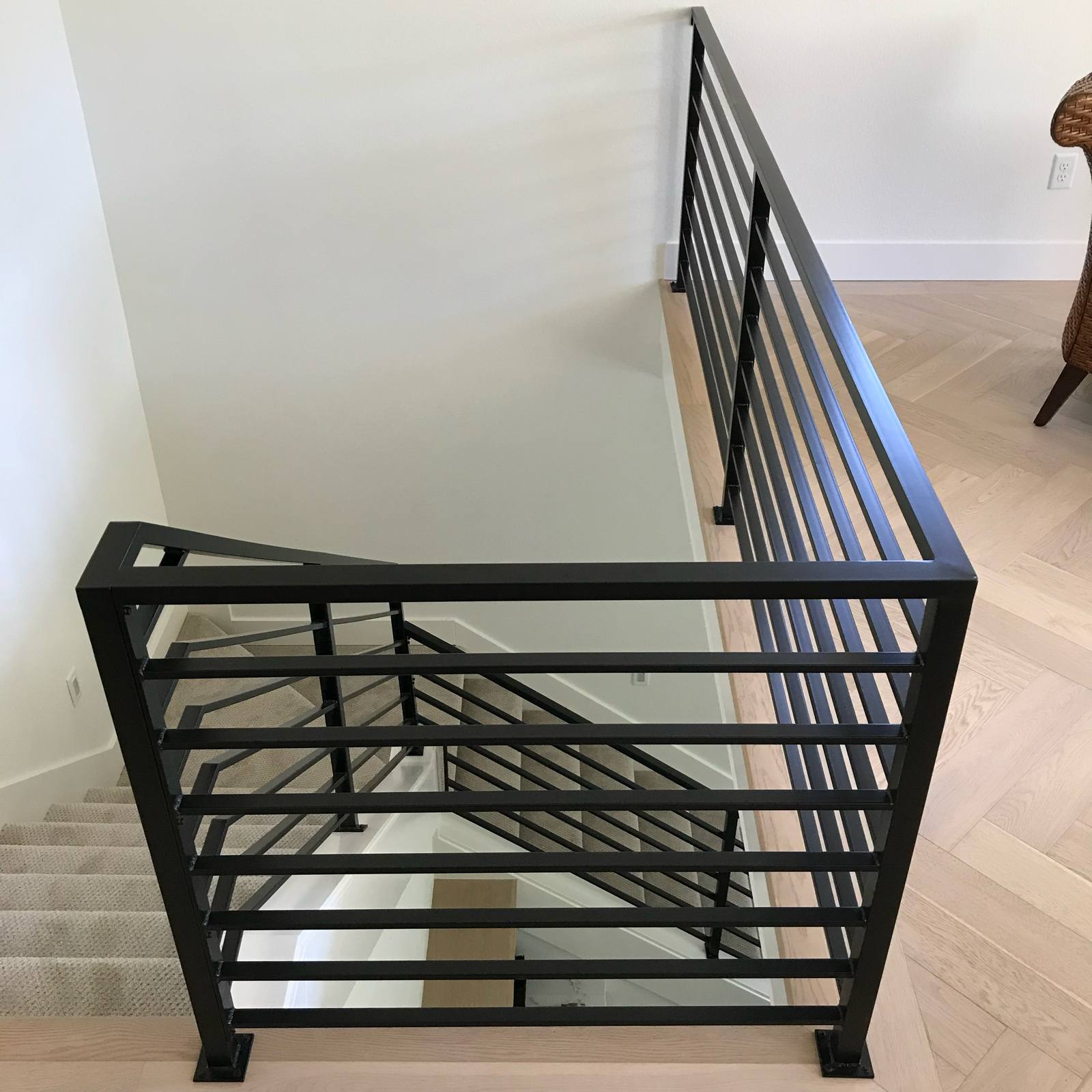 Modern horizontal-bar metal guardrail at an upstairs landing — custom metal railing, Portland
