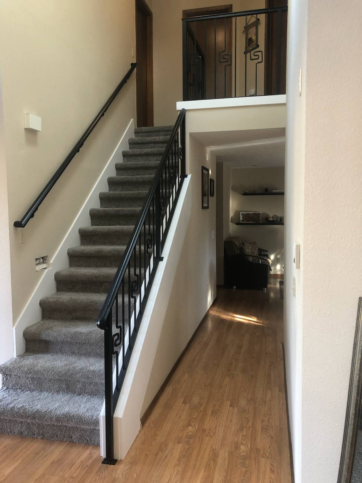 Black vertical-picket metal stair railing — measured, welded and installed on site