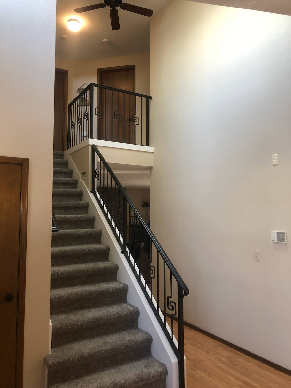Black vertical-picket metal stair railing in a Vancouver, WA area home