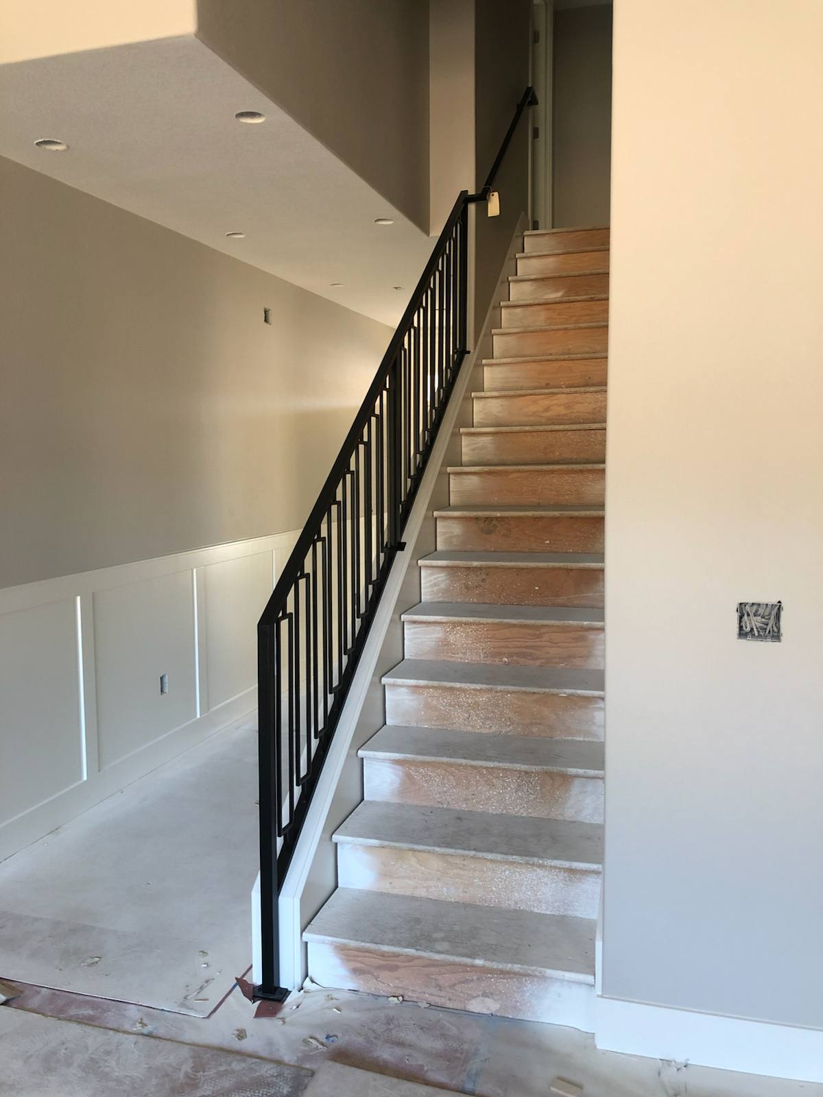 Black vertical-picket metal stair railing — custom built and installed in Portland, OR