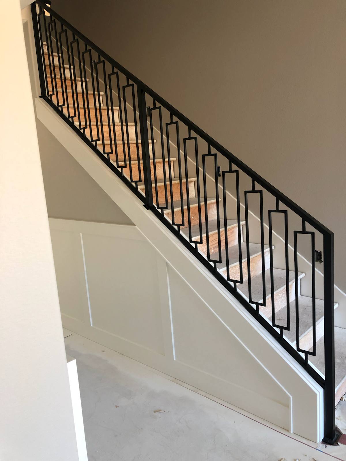 Decorative geometric metal stair railing in a Portland-area home