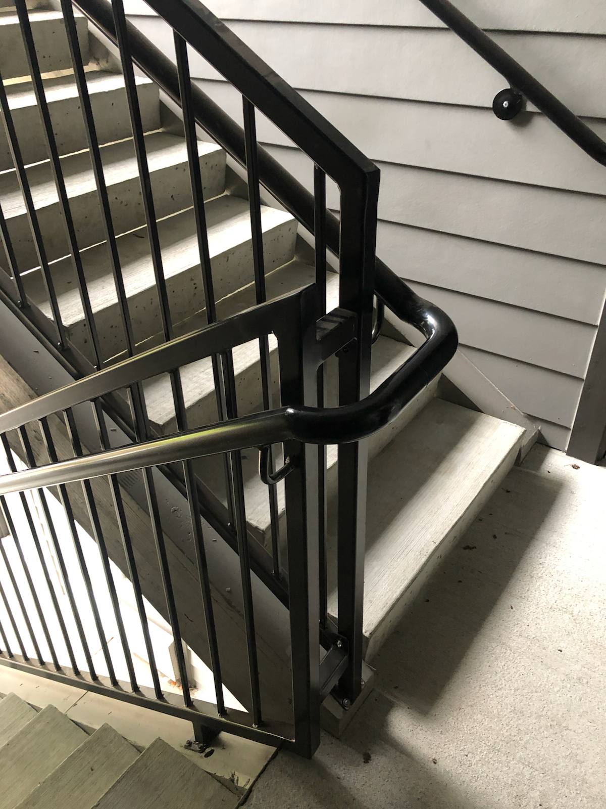 Close-up of a custom welded metal handrail — measured, welded and installed on site