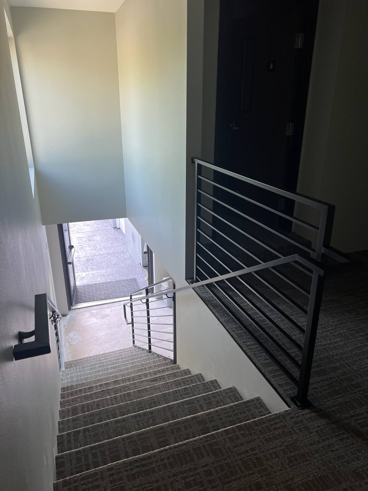 Modern horizontal-bar metal stair railing in a Portland-area home
