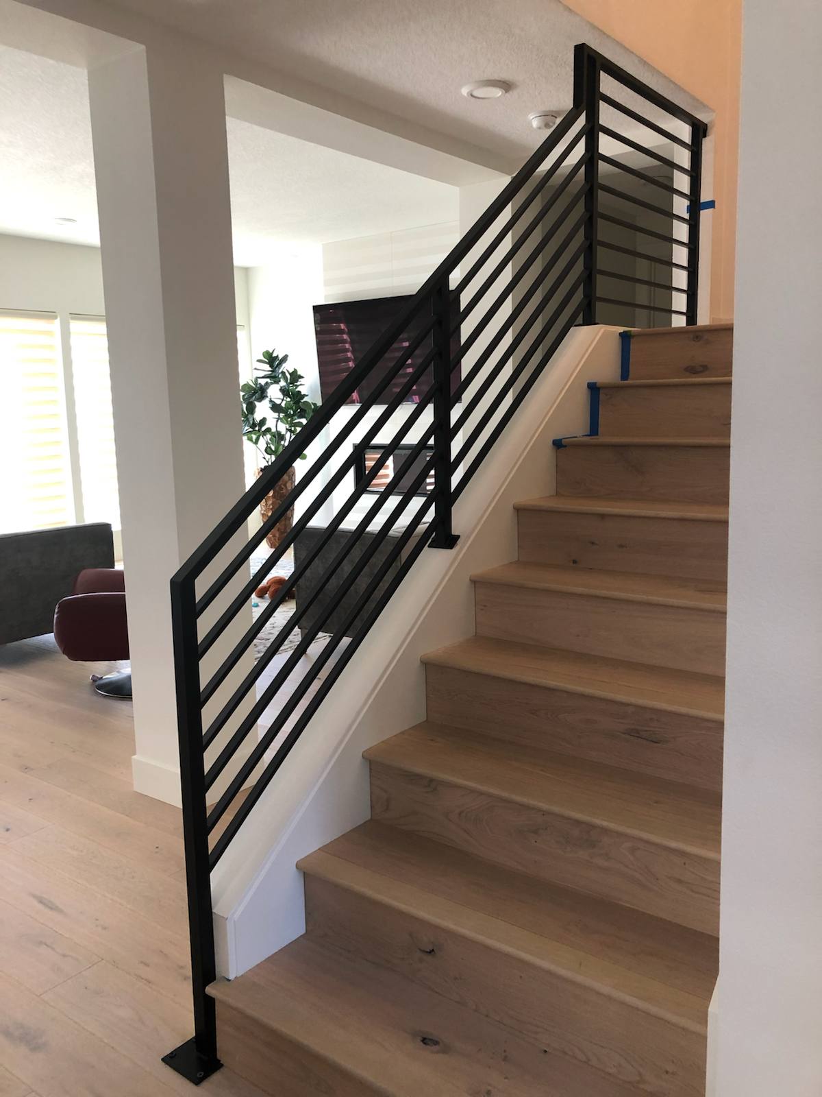 Black vertical-picket metal stair railing in a Vancouver, WA area home