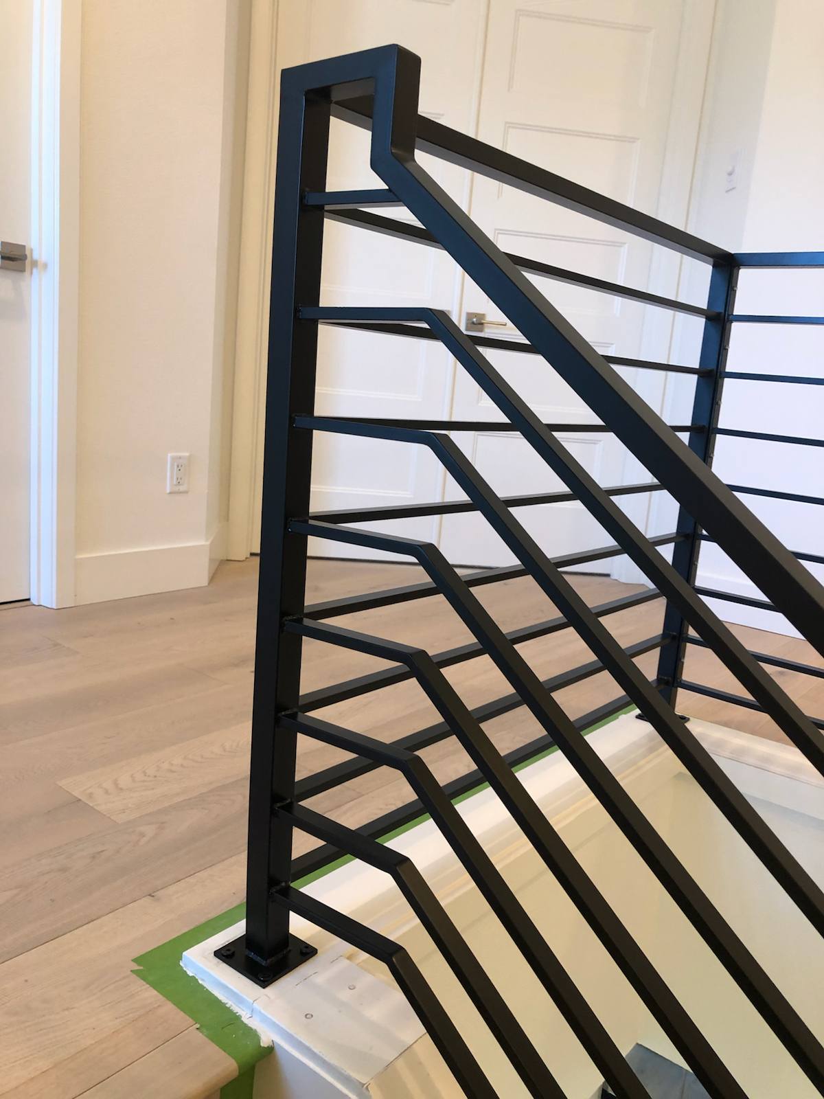 Modern horizontal-bar metal stair railing — custom built and installed in Portland, OR