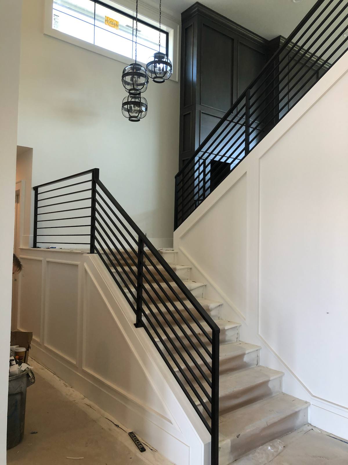 Black vertical-picket metal stair railing — measured, welded and installed on site