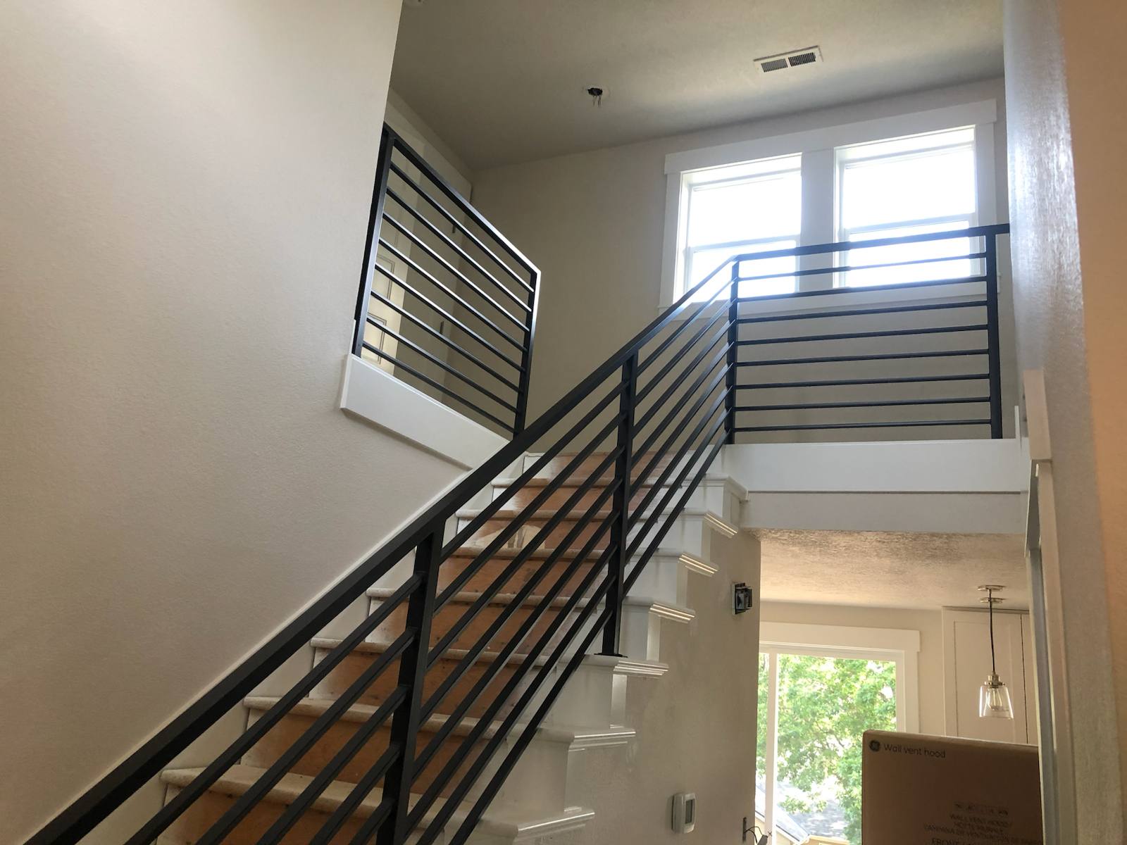Modern horizontal-bar metal stair railing — custom built and installed in Portland, OR