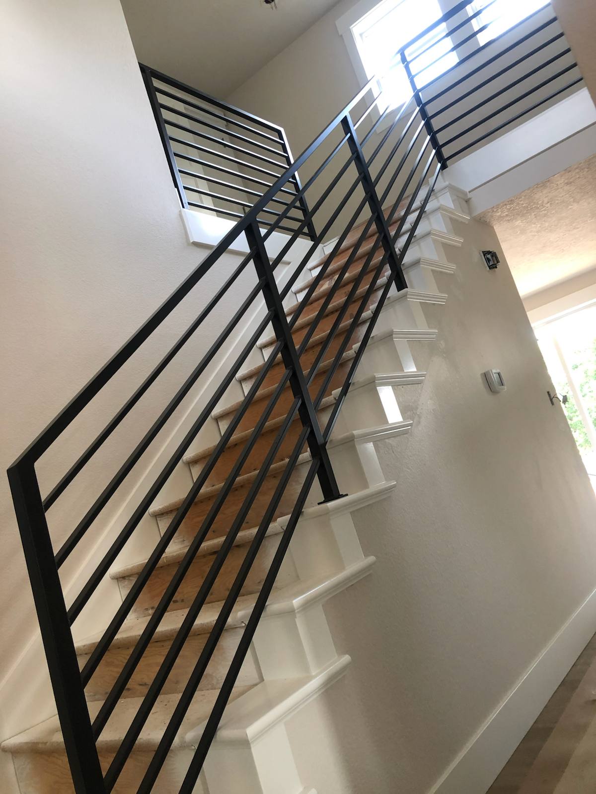 Modern horizontal-bar metal stair railing in a Portland-area home