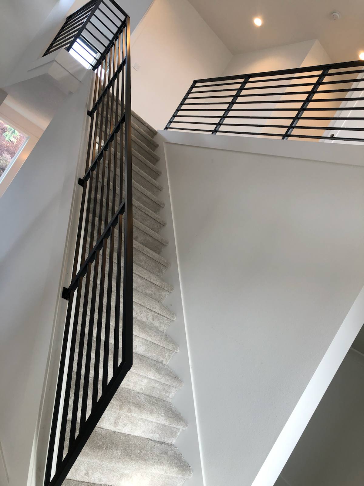 Modern horizontal-bar metal stair railing in a Vancouver, WA area home