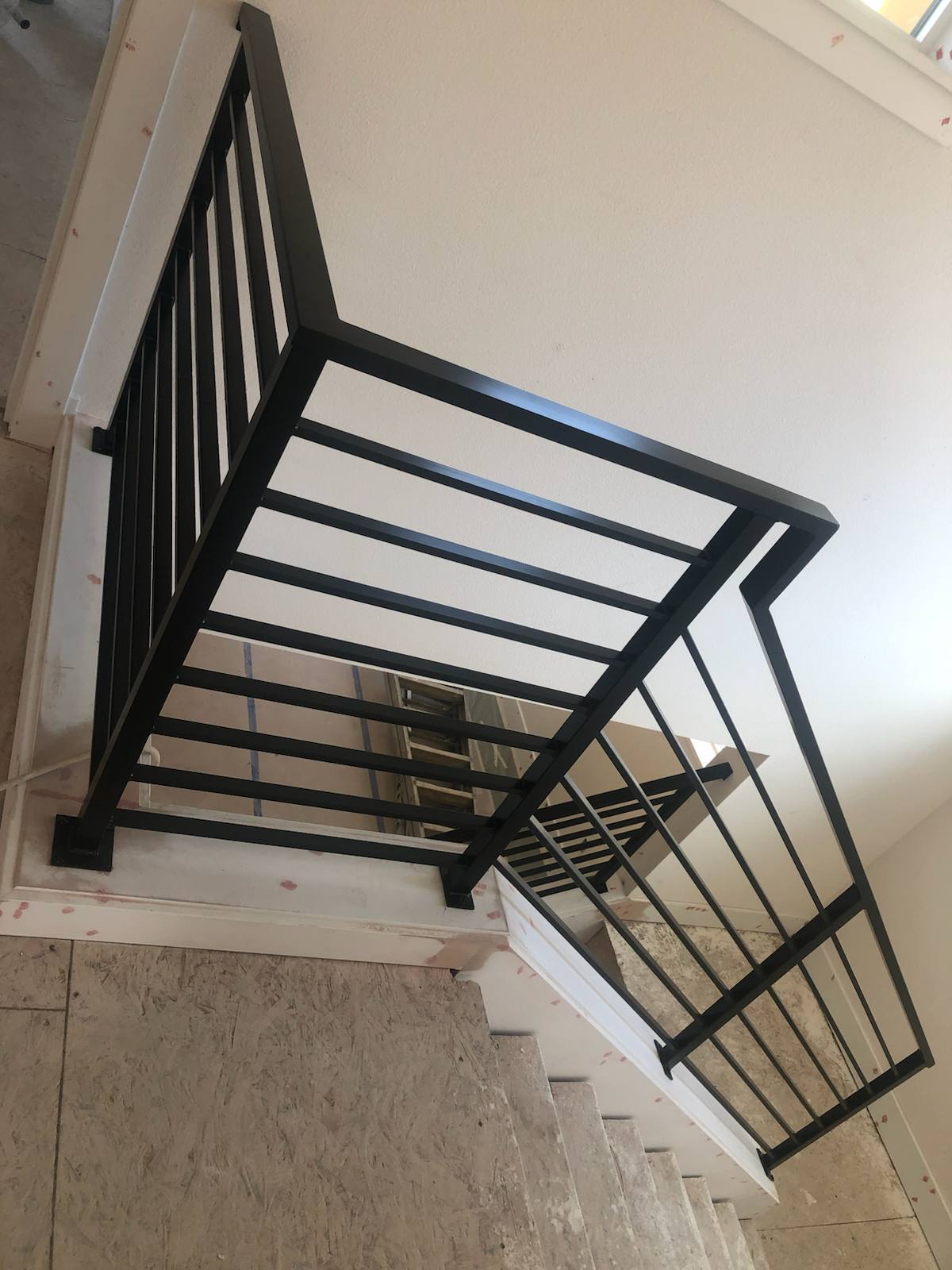 Modern horizontal-bar metal stair railing in a Portland-area home