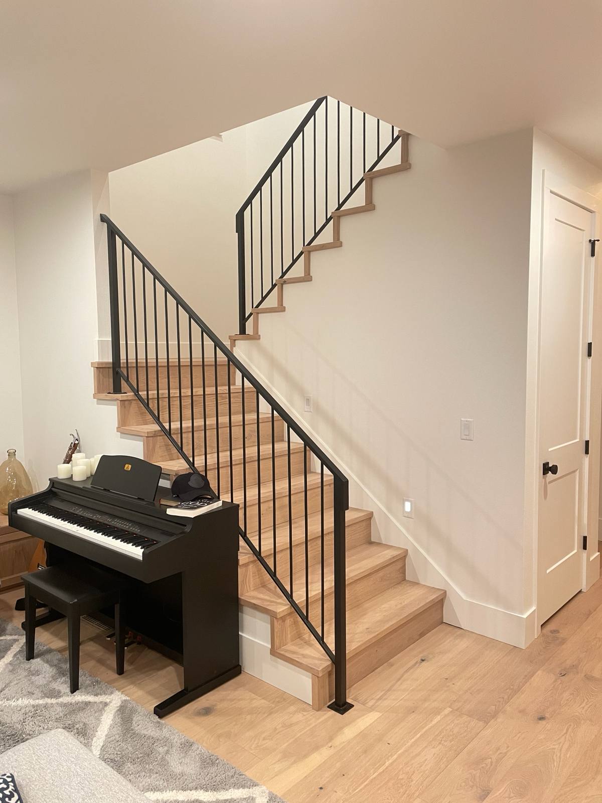 Black vertical-picket metal stair railing — custom built and installed in Portland, OR