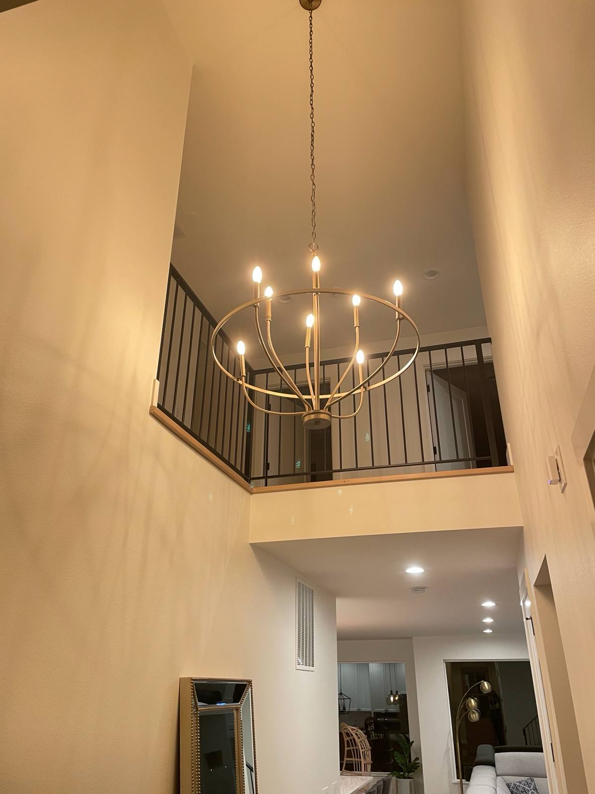 Black metal balcony railing overlooking a two-story entry in a Portland-area home