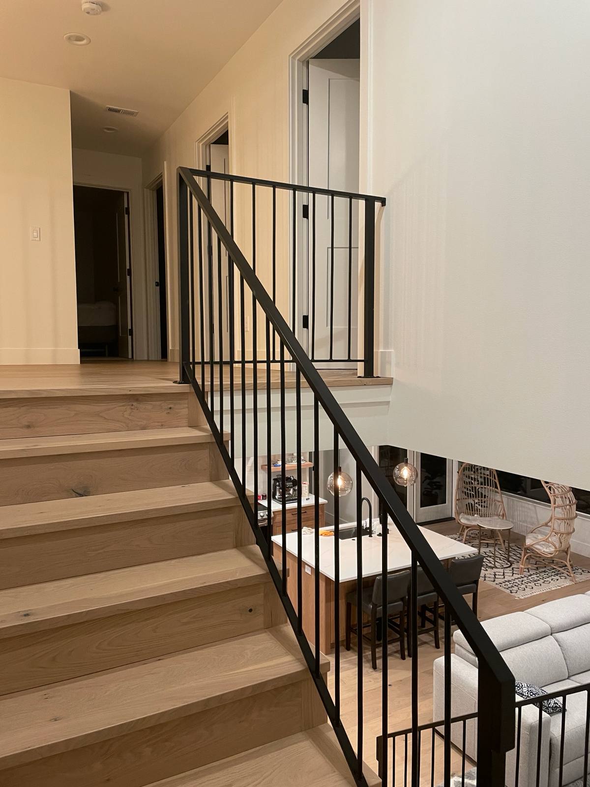 Black vertical-picket metal stair railing — measured, welded and installed on site