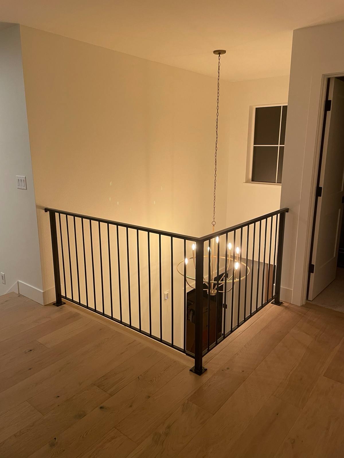 Black vertical-picket metal guardrail at an upstairs landing in a Vancouver, WA area home