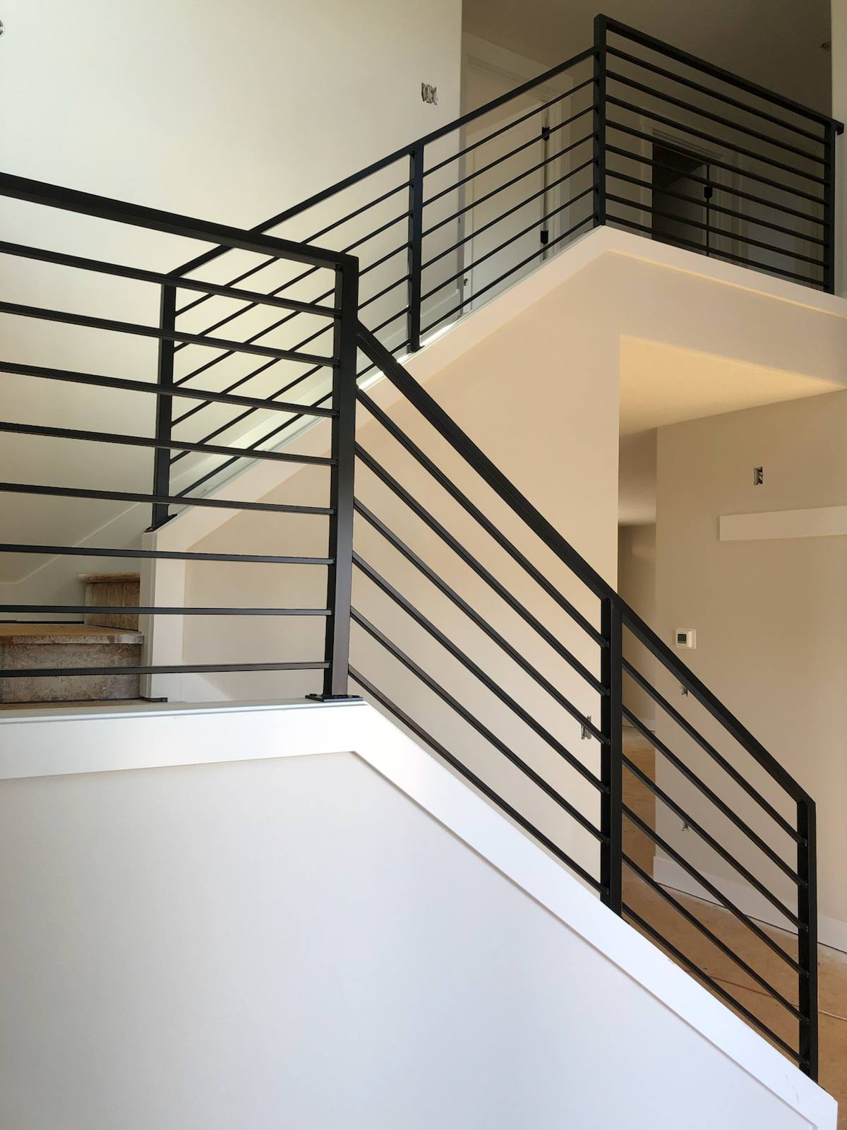 Modern horizontal-bar metal stair railing — custom built and installed in Portland, OR