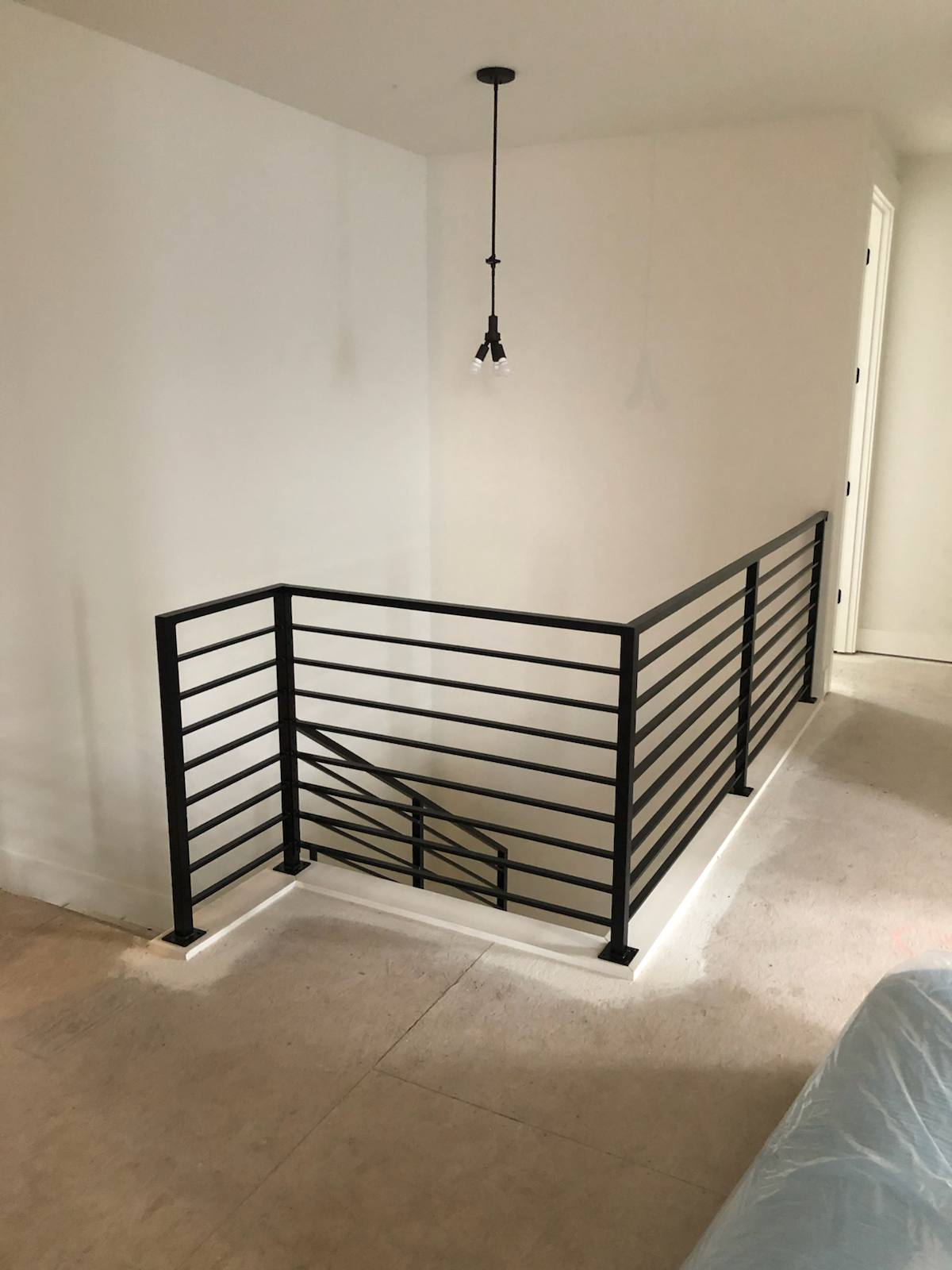 Modern horizontal-bar metal guardrail at an upstairs landing in a Portland-area home