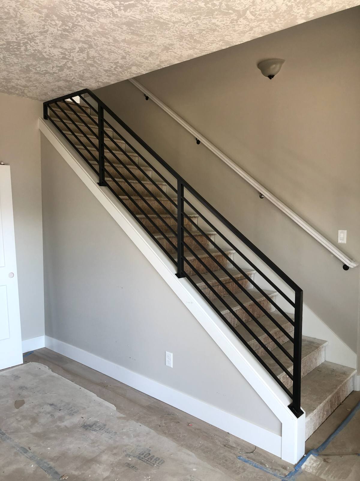 Modern horizontal-bar metal stair railing in a Vancouver, WA area home