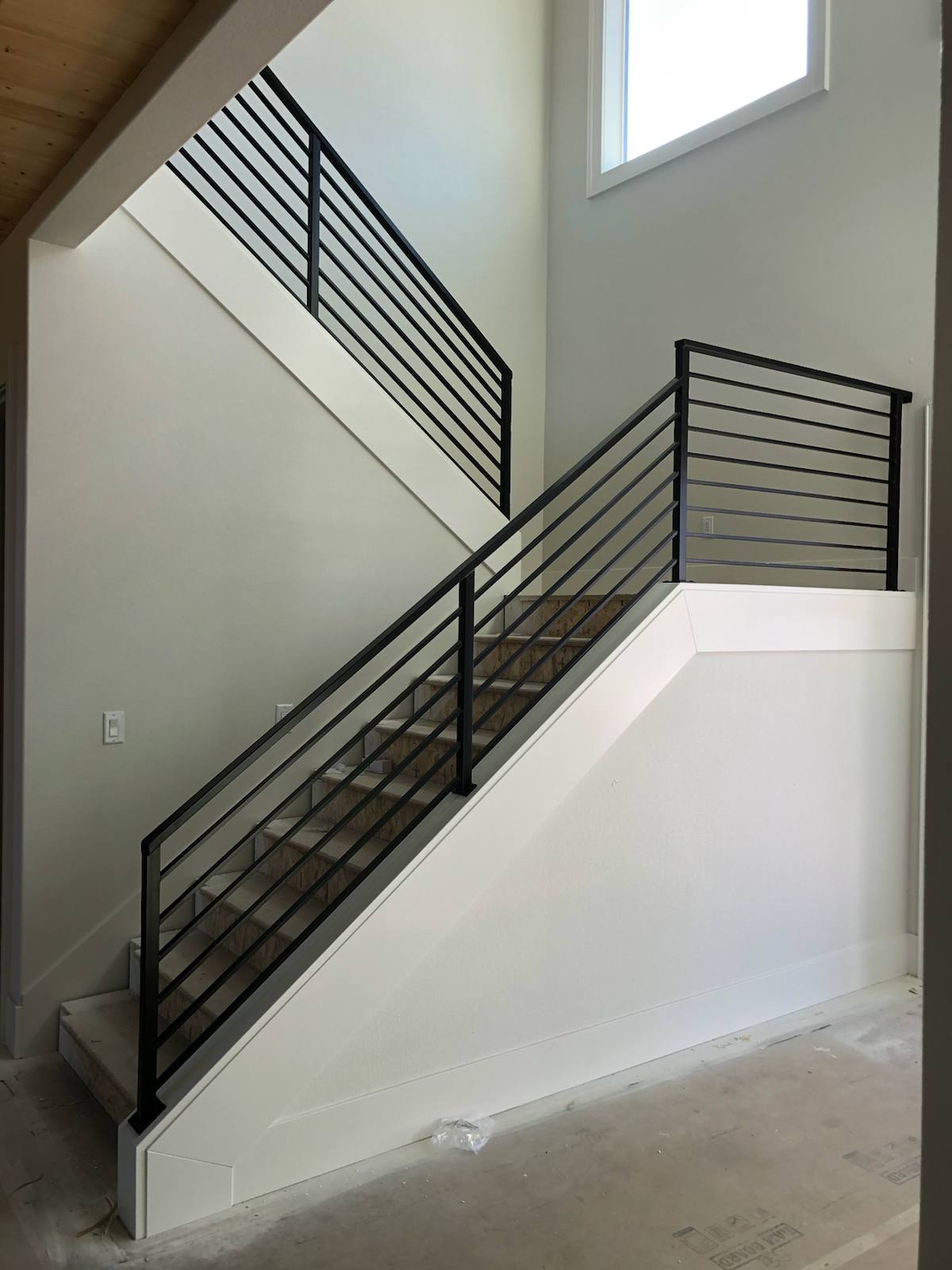 Modern horizontal-bar metal stair railing — custom built and installed in Portland, OR