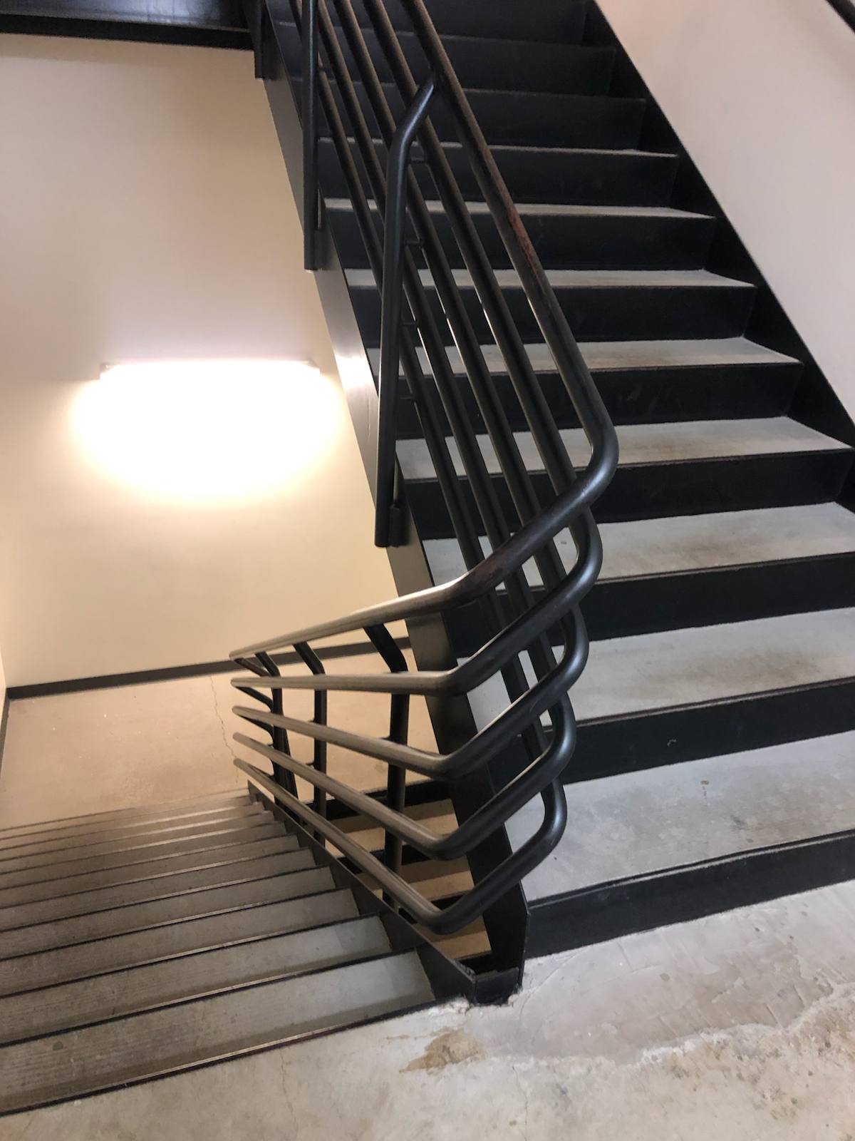 Modern horizontal-bar metal stair railing in a Portland-area home