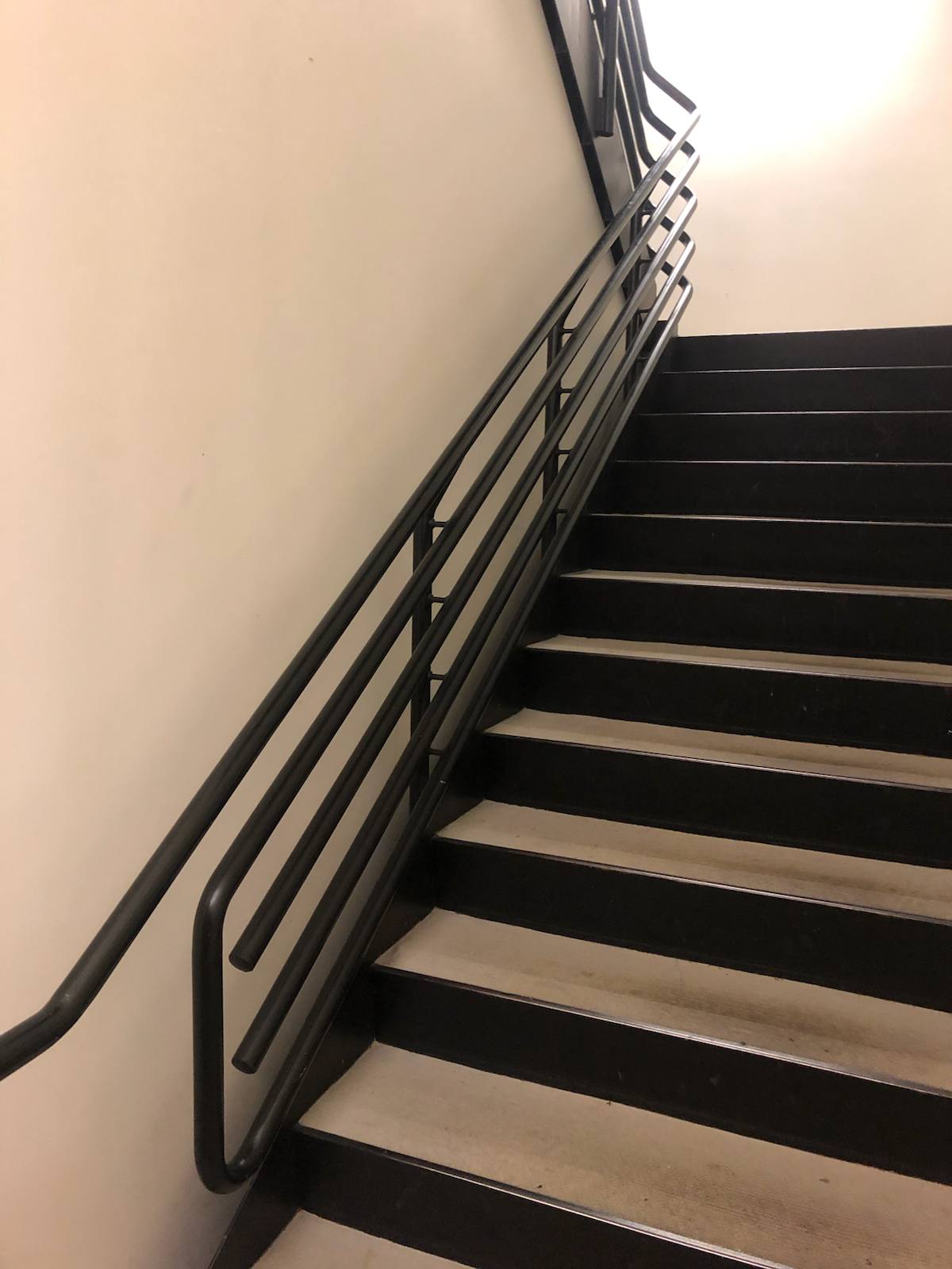 Modern horizontal-bar metal stair railing by Cascade Mobile Welding