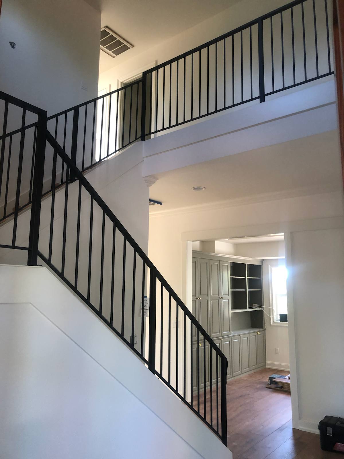Black vertical-picket metal stair railing in a Vancouver, WA area home