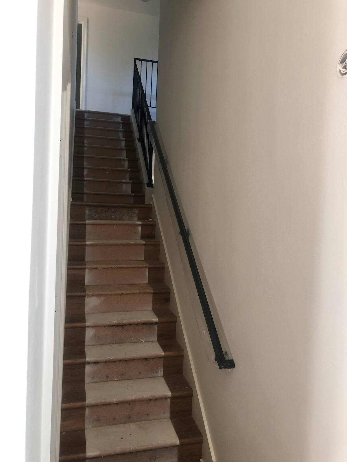Wall-mounted black metal handrail — custom metal railing, Portland