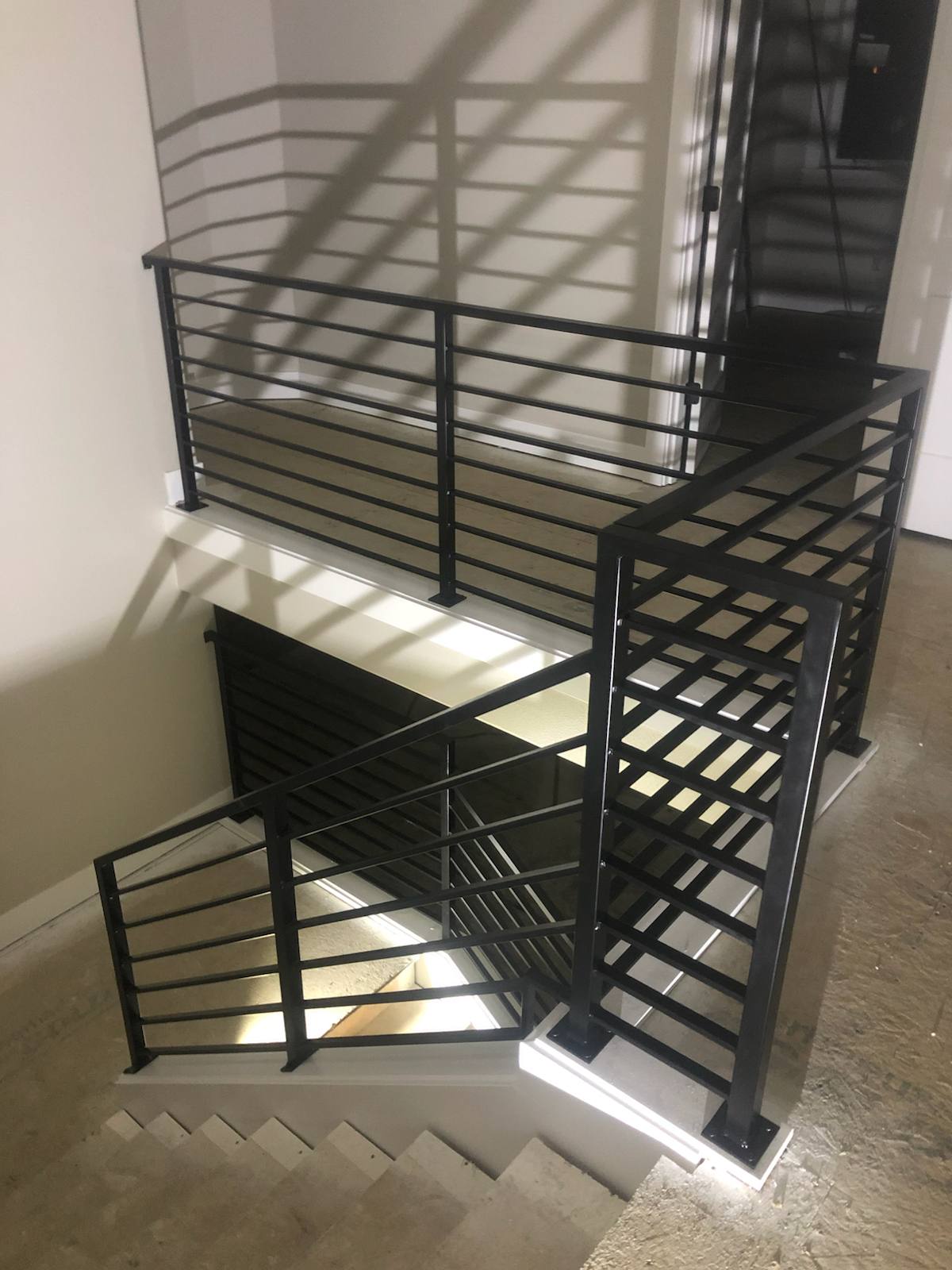 Modern horizontal-bar metal stair railing in a Portland-area home