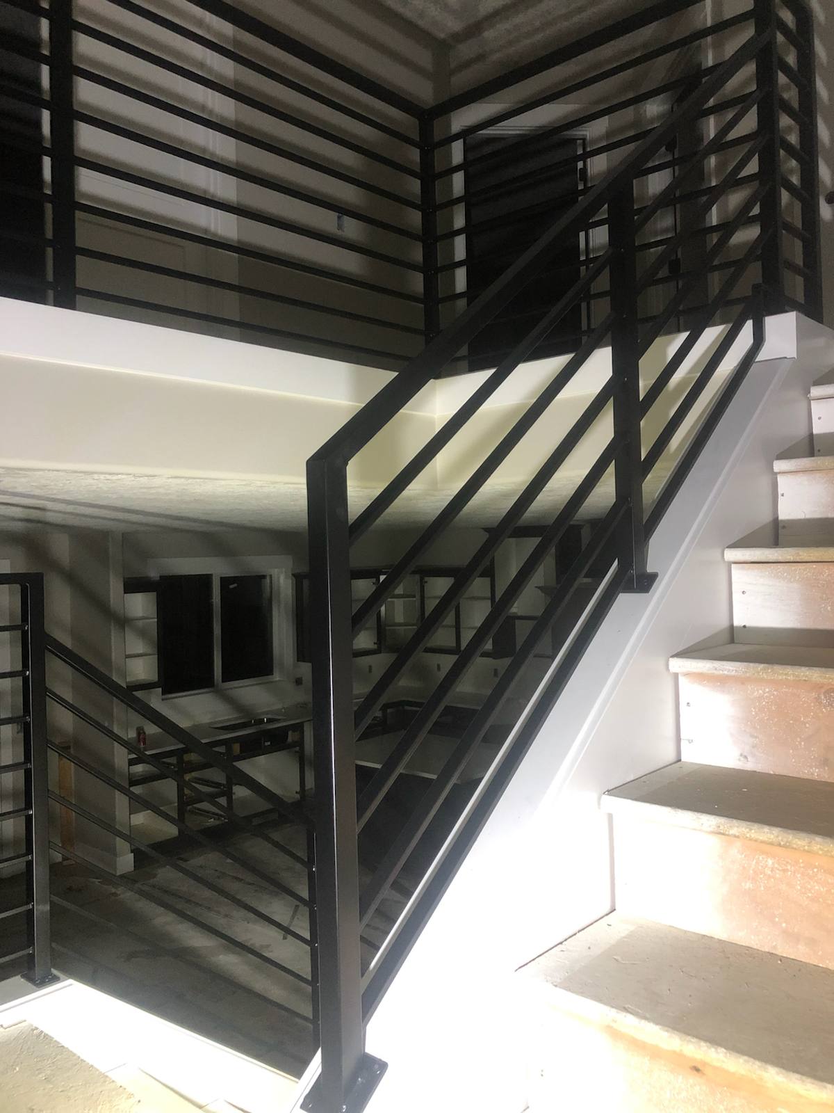 Modern horizontal-bar metal stair railing — measured, welded and installed on site
