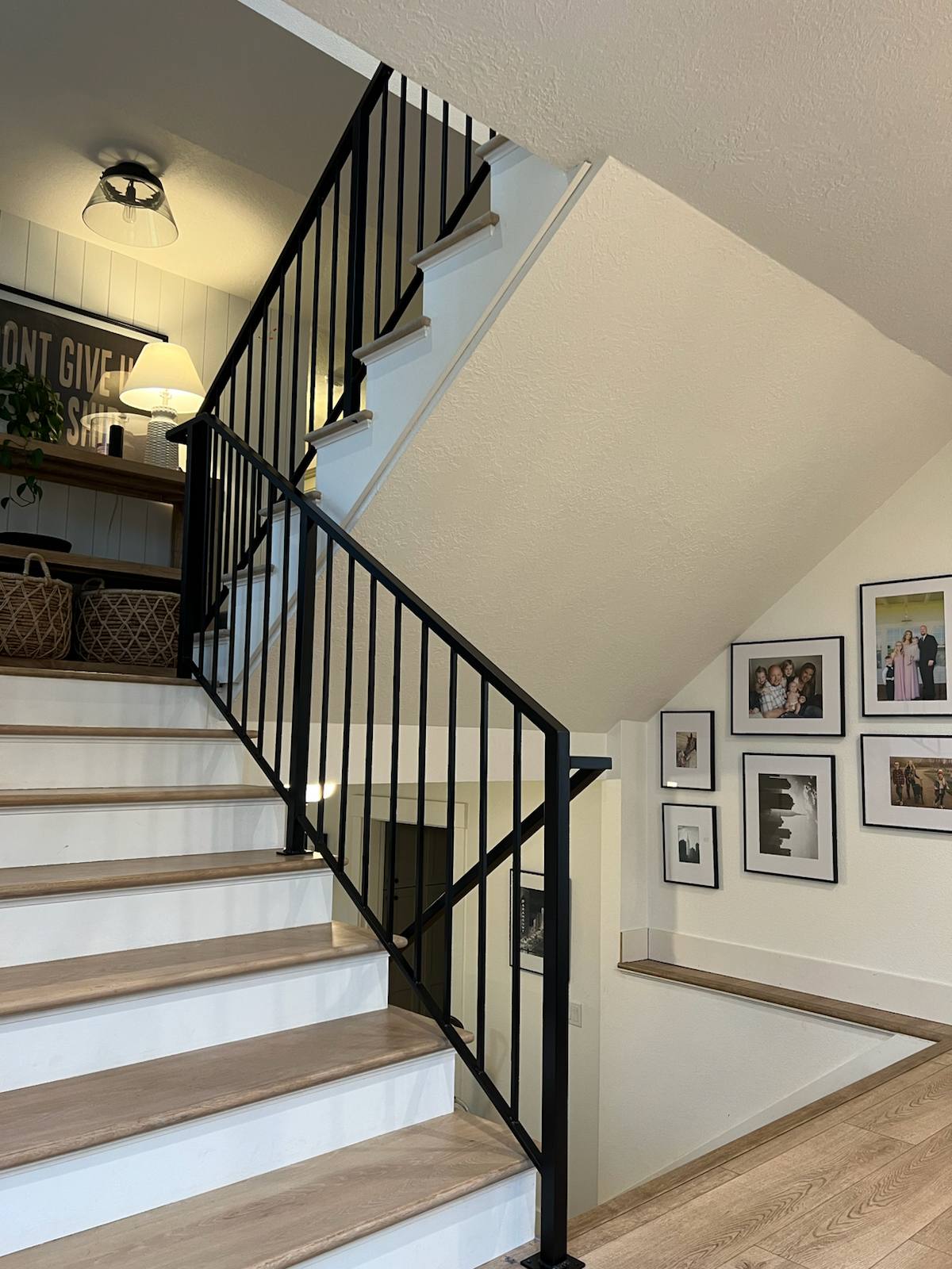 Black vertical-picket metal stair railing by Cascade Mobile Welding