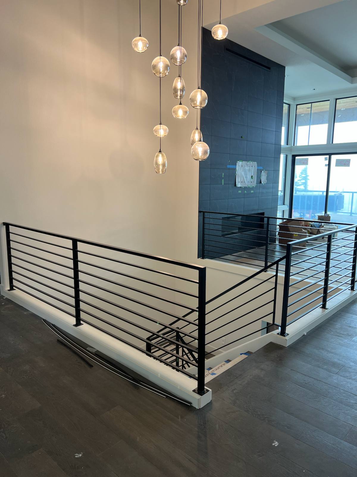 Modern horizontal-bar metal guardrail at an upstairs landing — custom metal railing, Portland