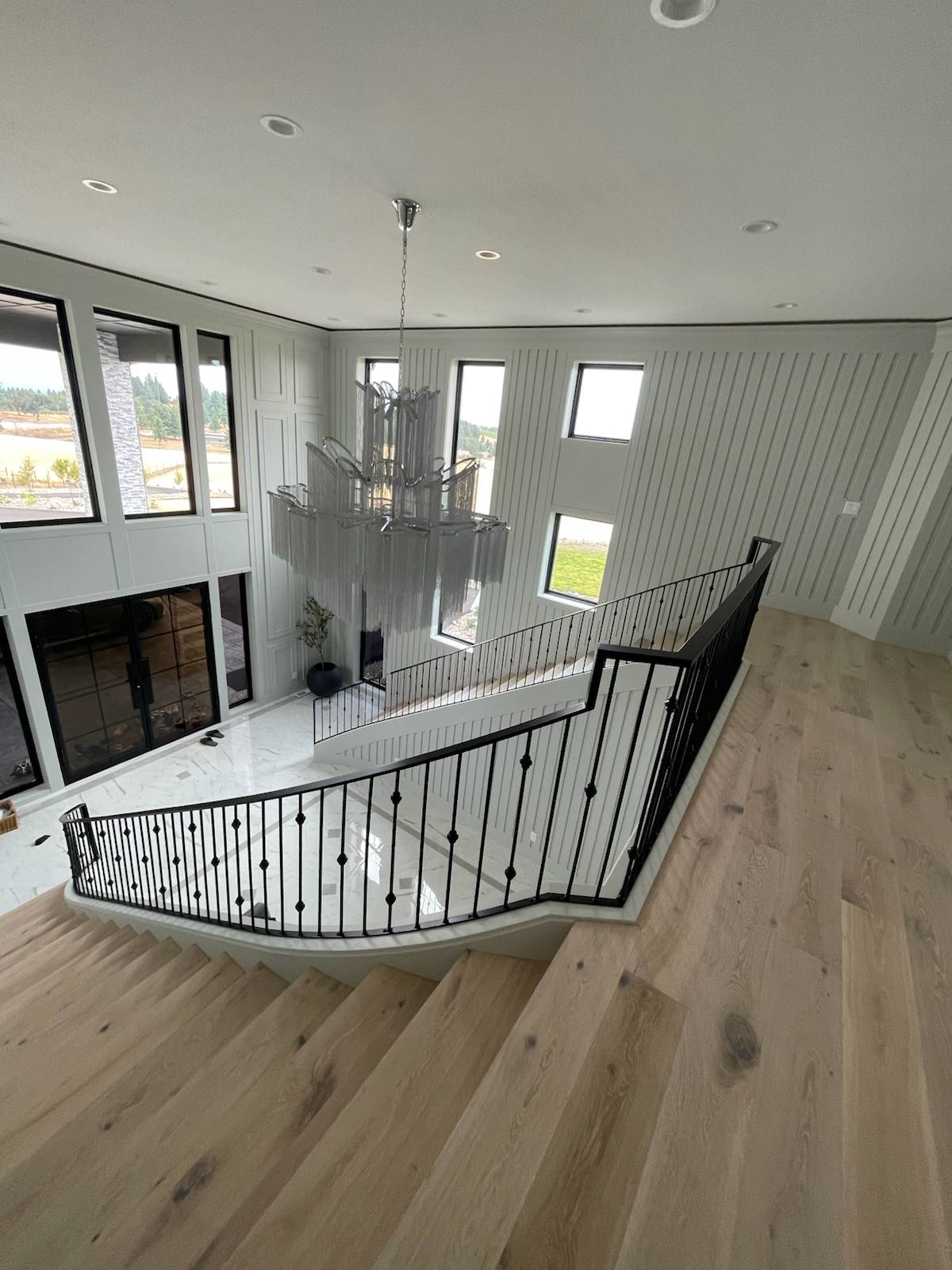 Black metal balcony railing overlooking a two-story entry — measured, welded and installed on site