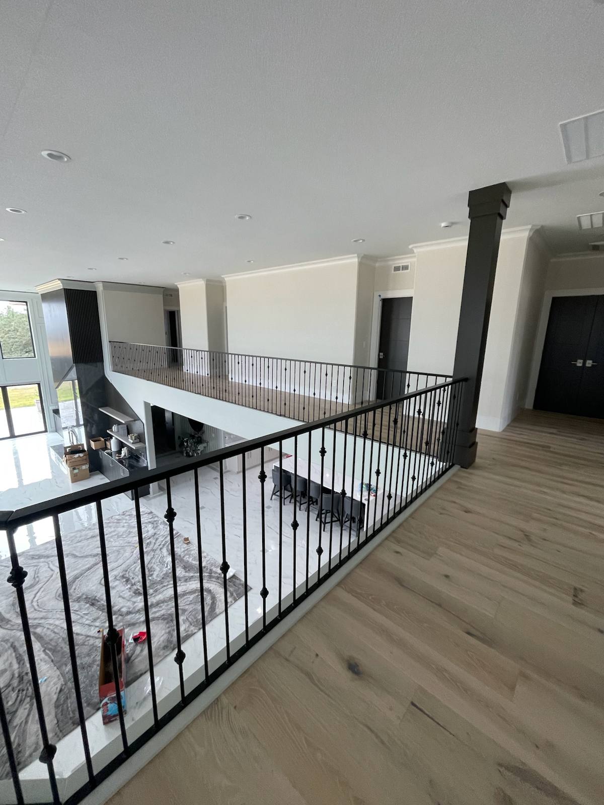 Black metal balcony railing overlooking a two-story entry in a Vancouver, WA area home