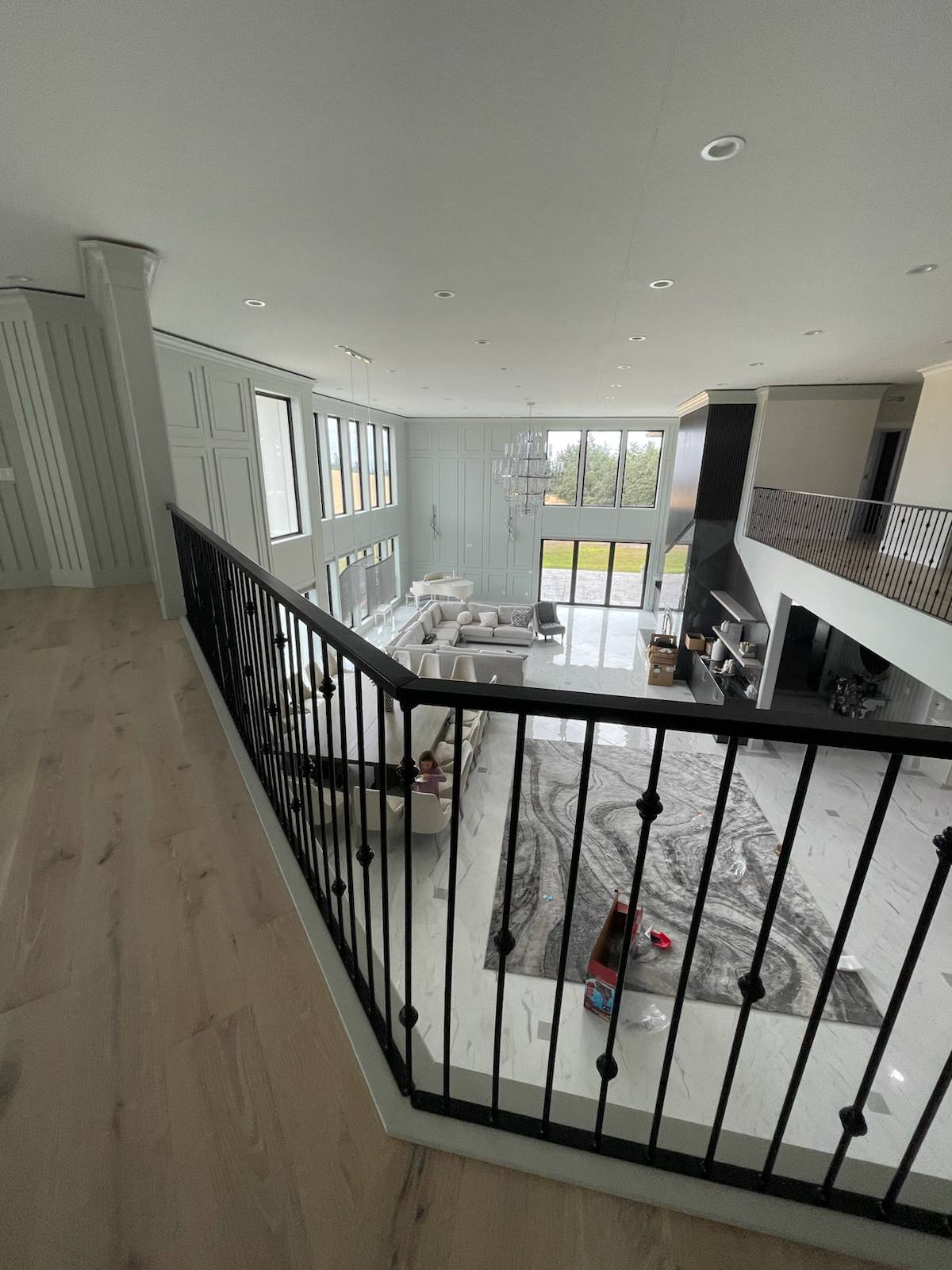 Black metal balcony railing overlooking a two-story entry — custom metal railing, Portland