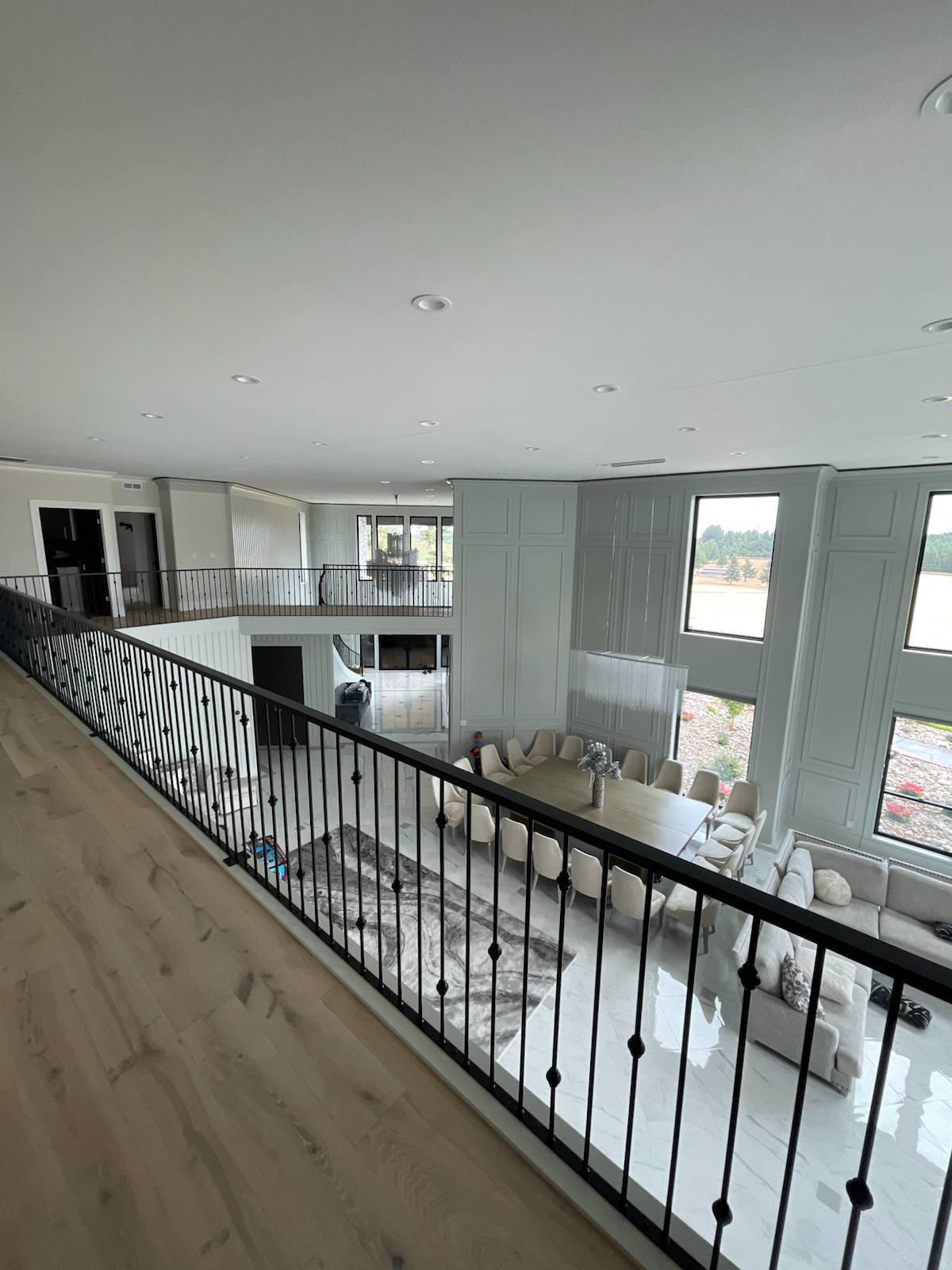 Black metal balcony railing overlooking a two-story entry — custom built and installed in Portland, OR