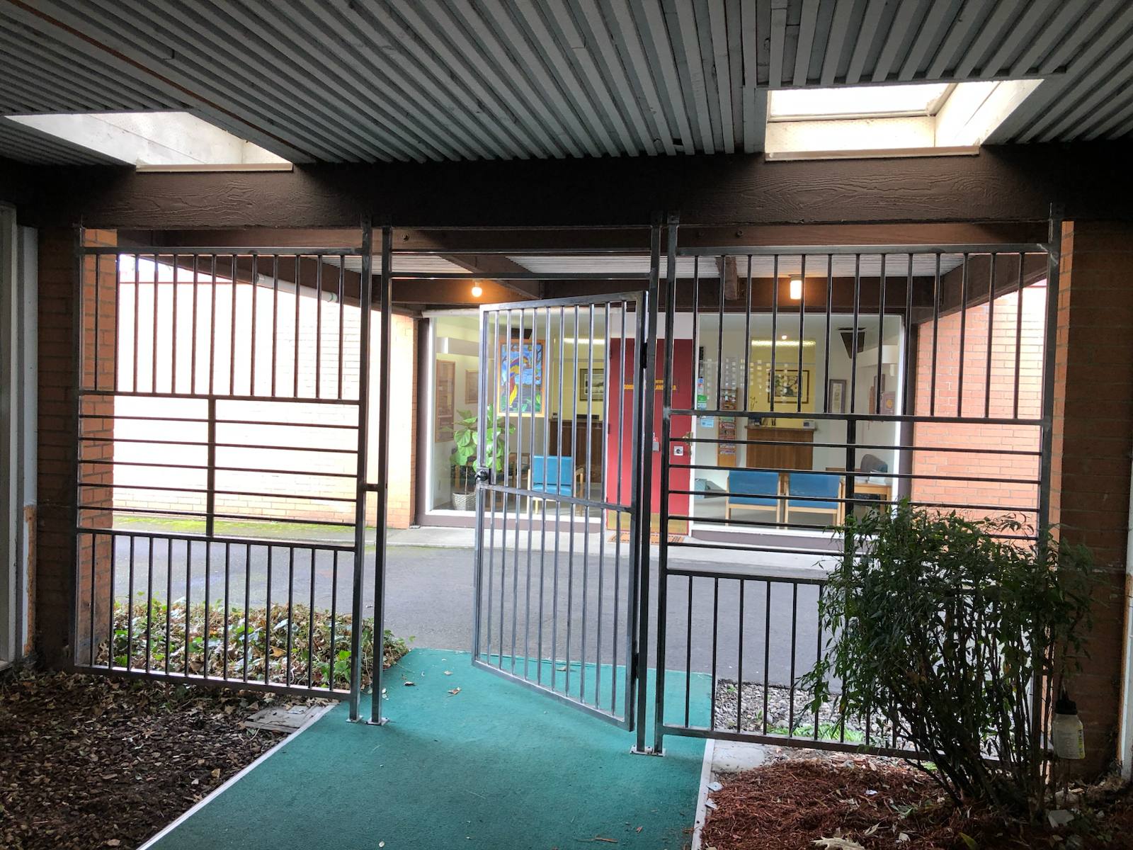 Steel security gate at a building entrance by Cascade Mobile Welding