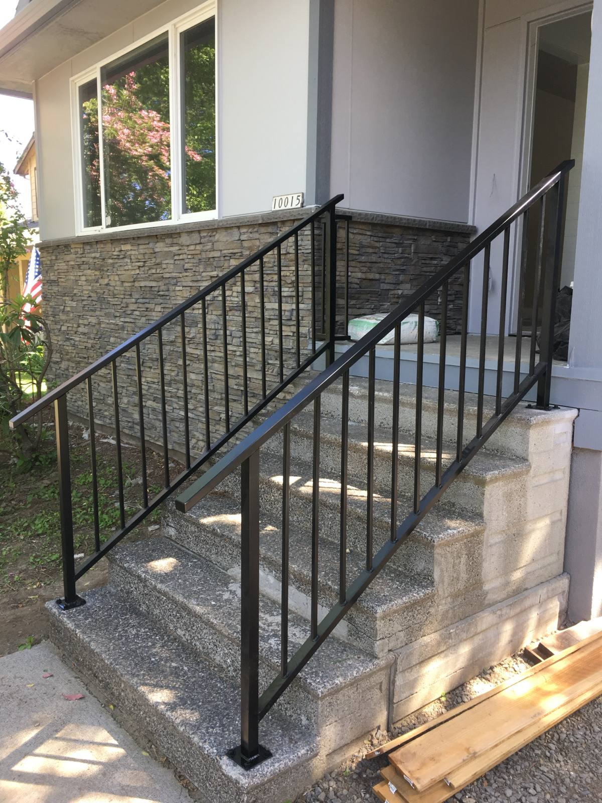 Black metal handrail on concrete front steps — Portland, OR