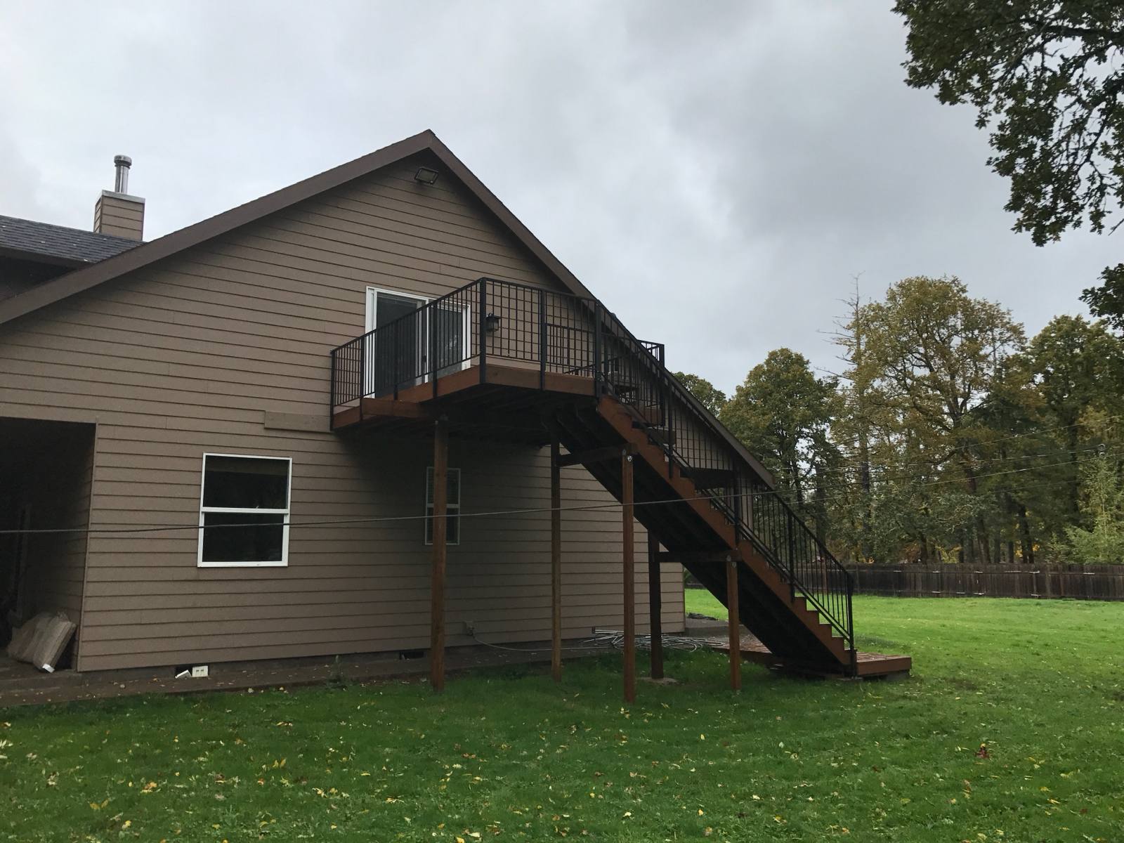 Metal railing on exterior deck stairs — welded and installed on site
