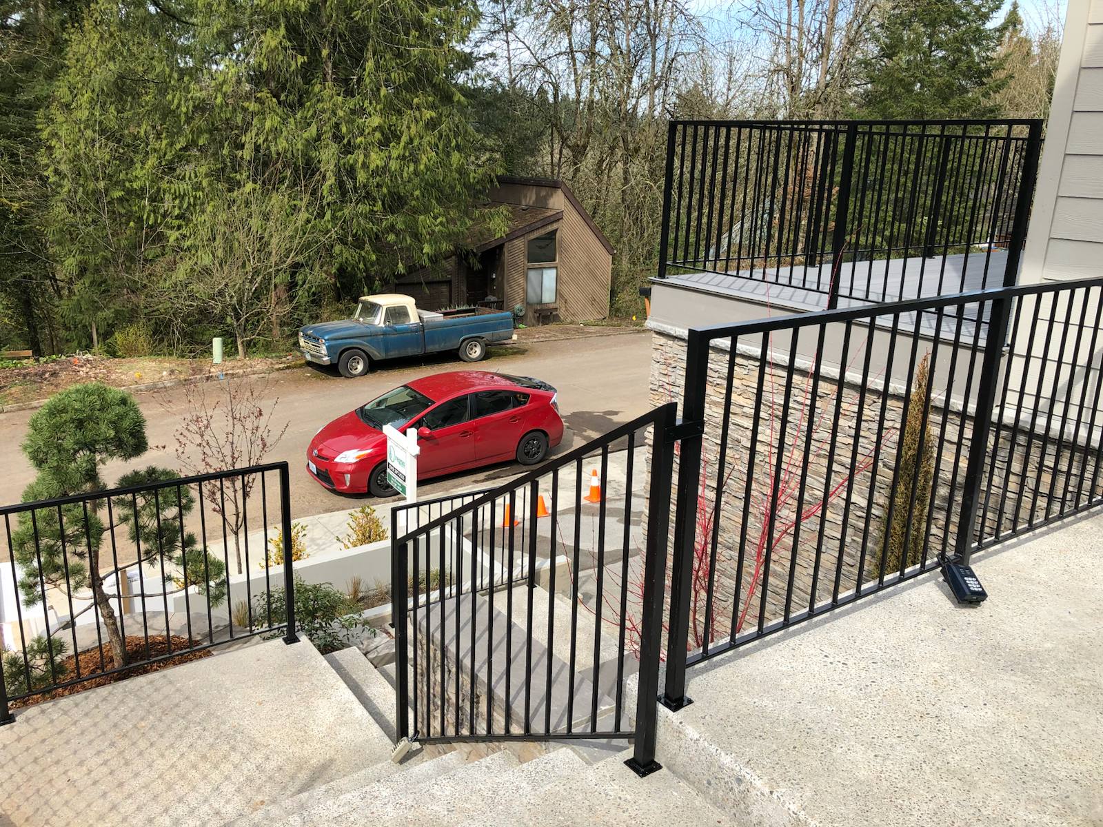 Metal handrail along an outdoor walkway and steps — welded and installed on site