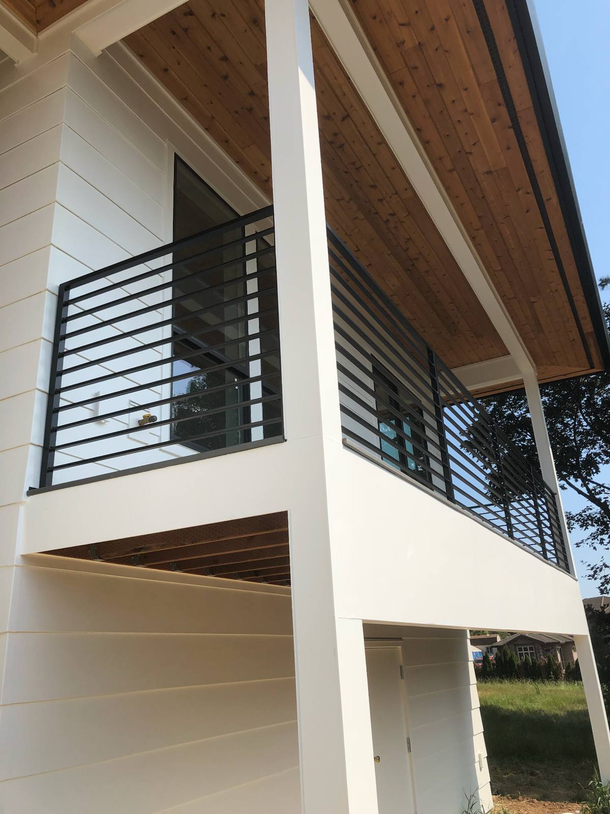 Modern metal deck railing on an elevated deck by Cascade Mobile Welding