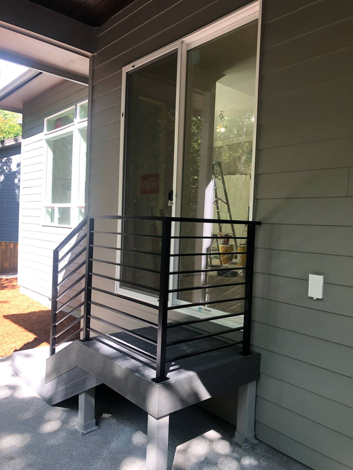 Black metal handrail on concrete front steps — Vancouver, WA area