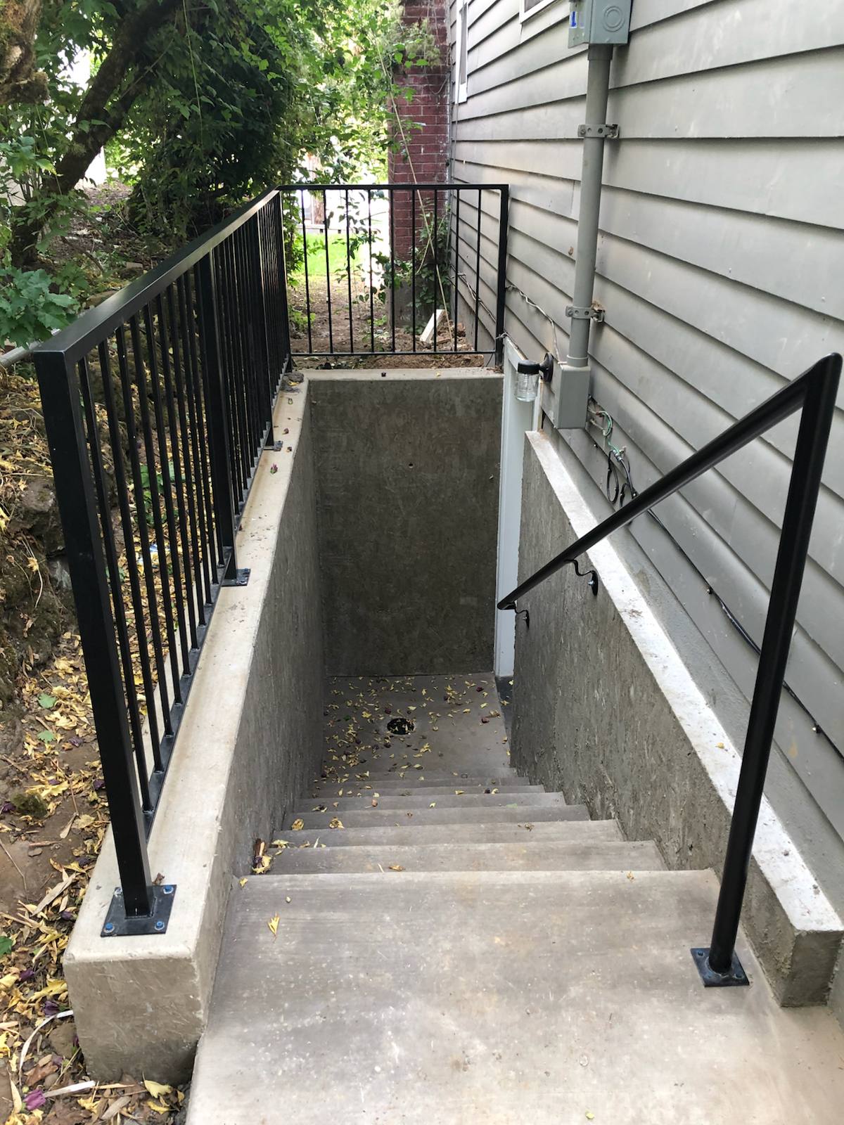 Metal handrail along an outdoor walkway and steps — custom metalwork, Portland